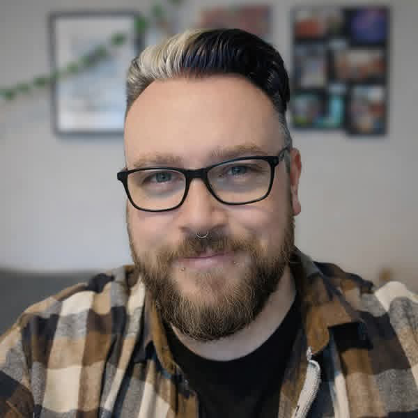 Independent designer sitting at a desk in a bright creative studio.